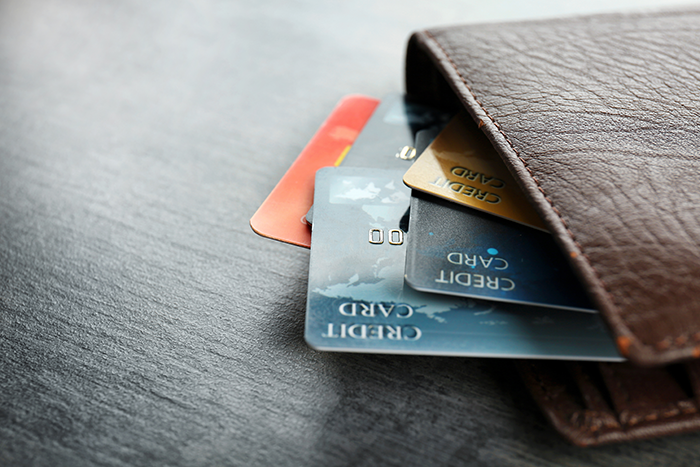 Brown leather wallet with credit cards sticking out of it