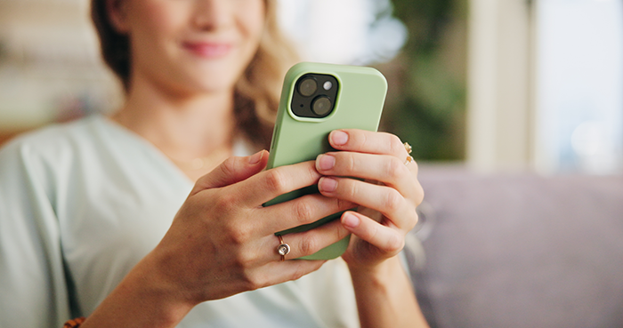 Woman smiling and holding a phone